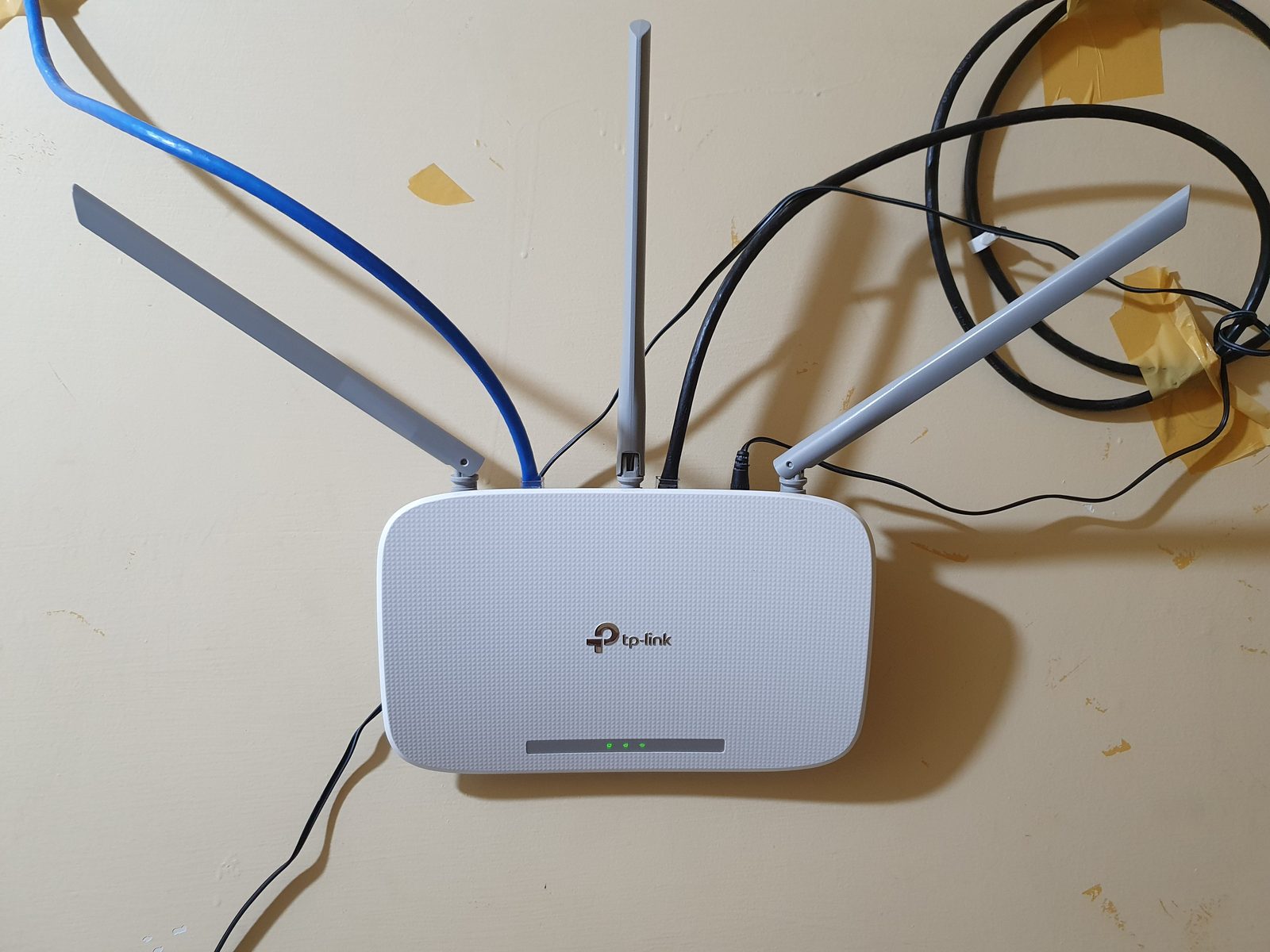 A wall-mounted TP-Link Wireless N router, model TL-WR845N.